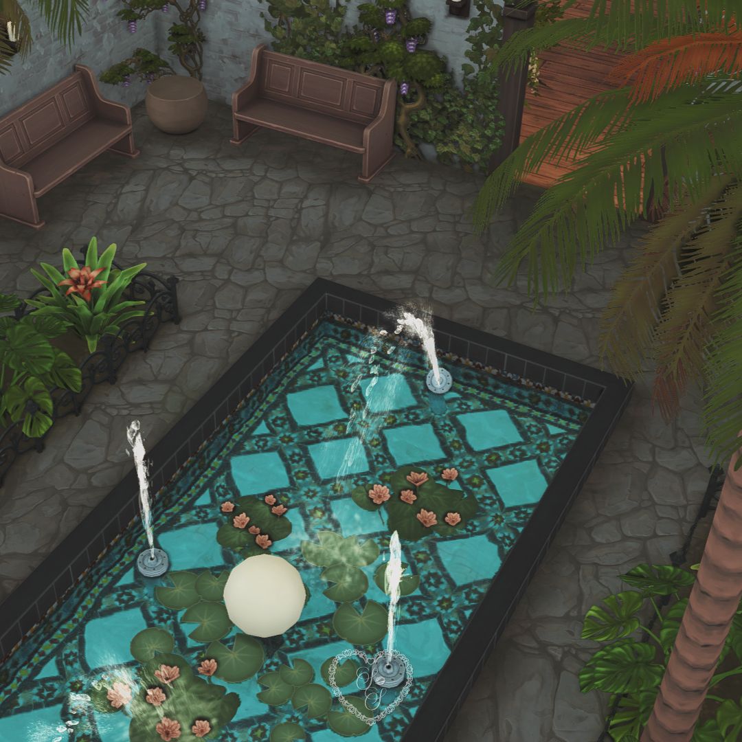 Fountain courtyard surrounded by greenery, benches, and palms
