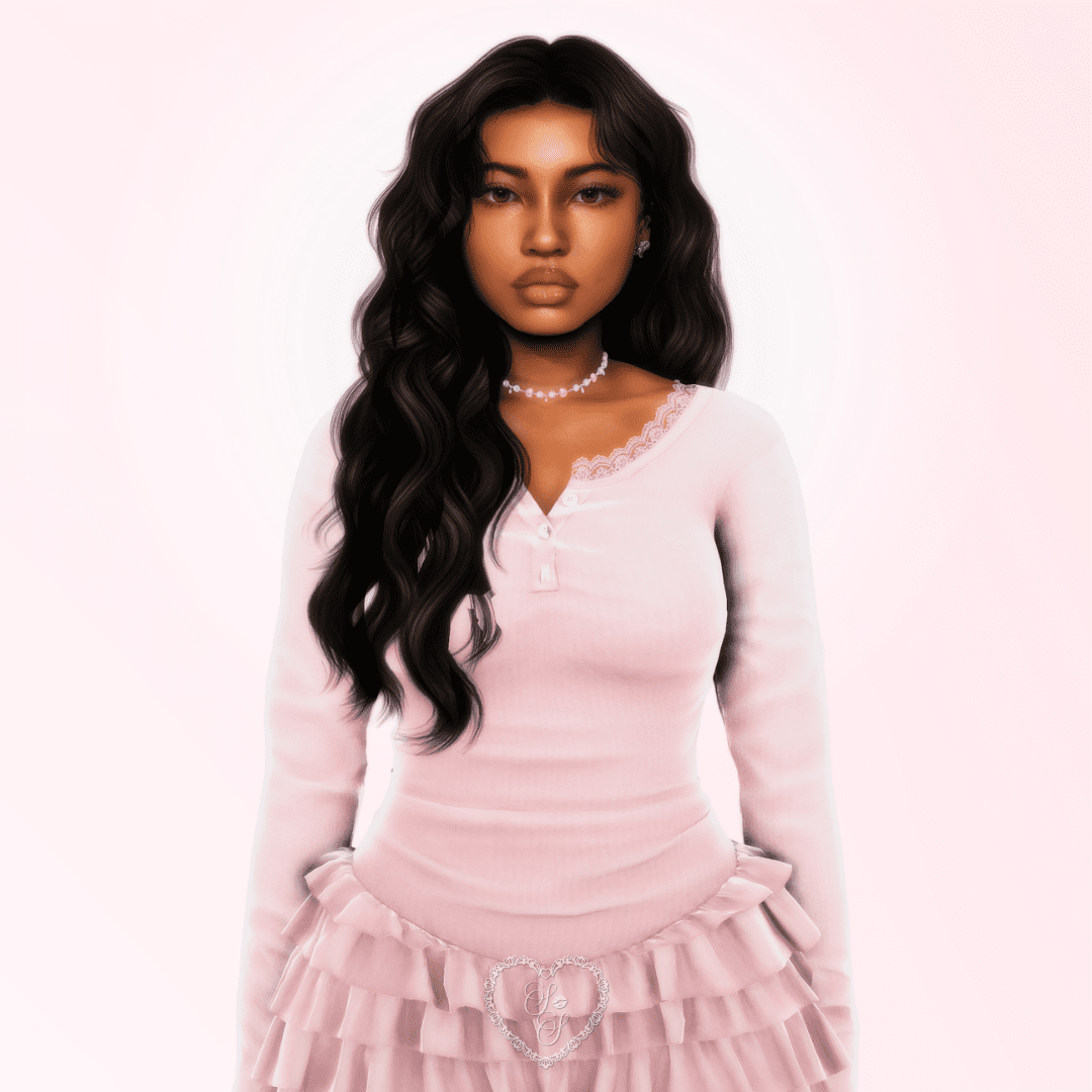 Close-up portrait of Cheyanne Douglas wearing a lace-trimmed blush pink top and ruffled skirt, with long wavy black hair and a soft expression.