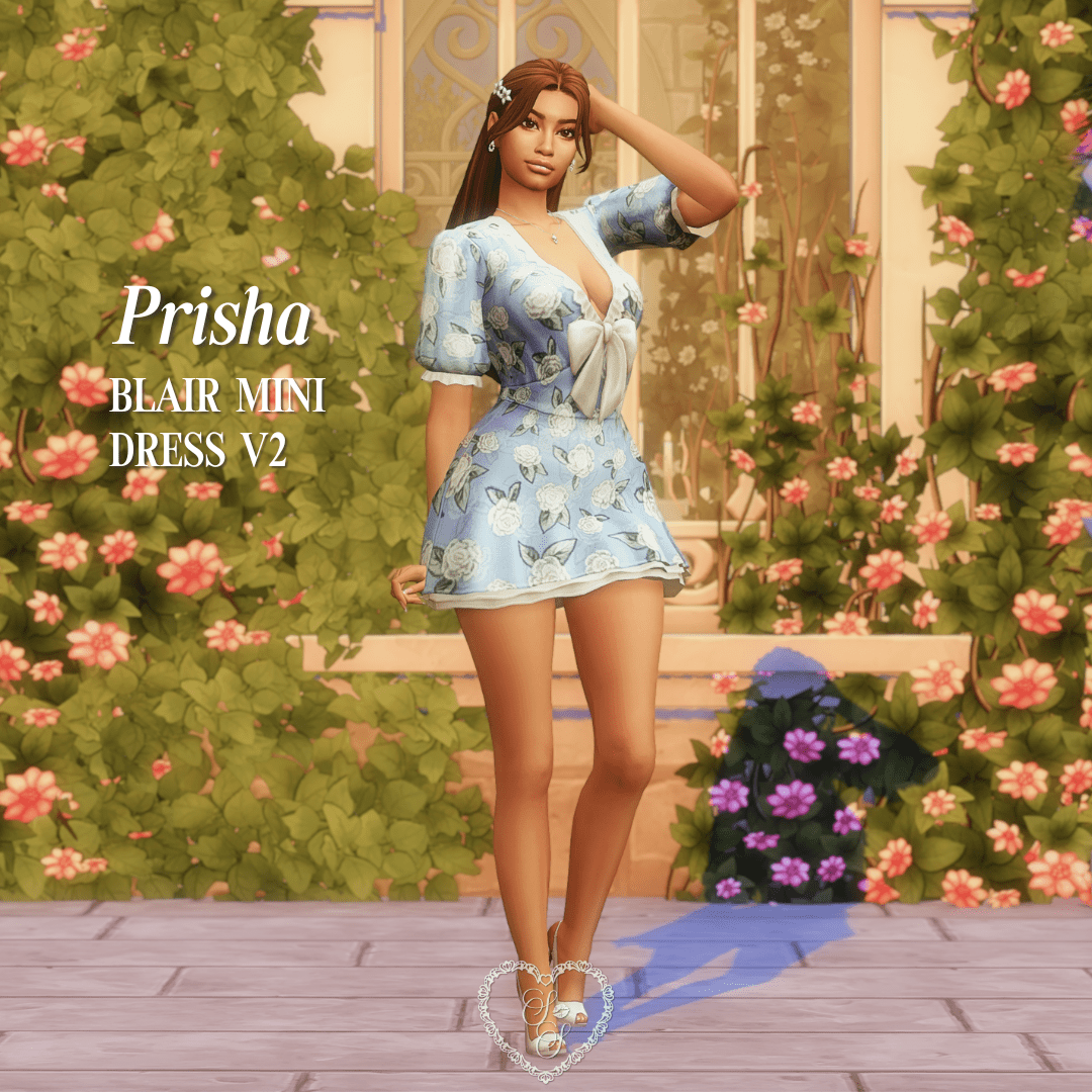 Prisha stands in front of a blooming floral wall wearing a short, powder blue dress with butterfly prints and puff sleeves.