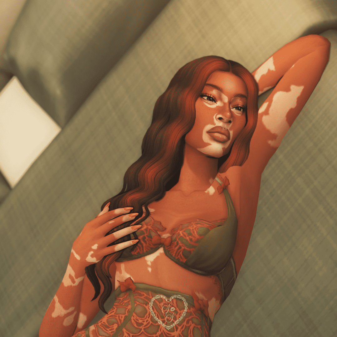 A flirty Sims 4 sim lying on a bed in olive green and orange lingerie, showing off soft glam makeup and long nails.