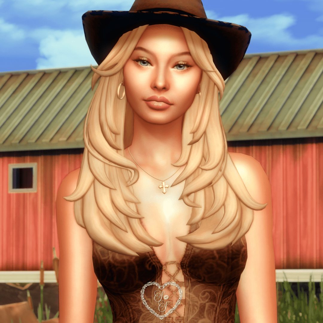 Close-up of Chasity with long blonde waves wearing the Callie hat and Bonnie top, standing in front of a rustic barn.