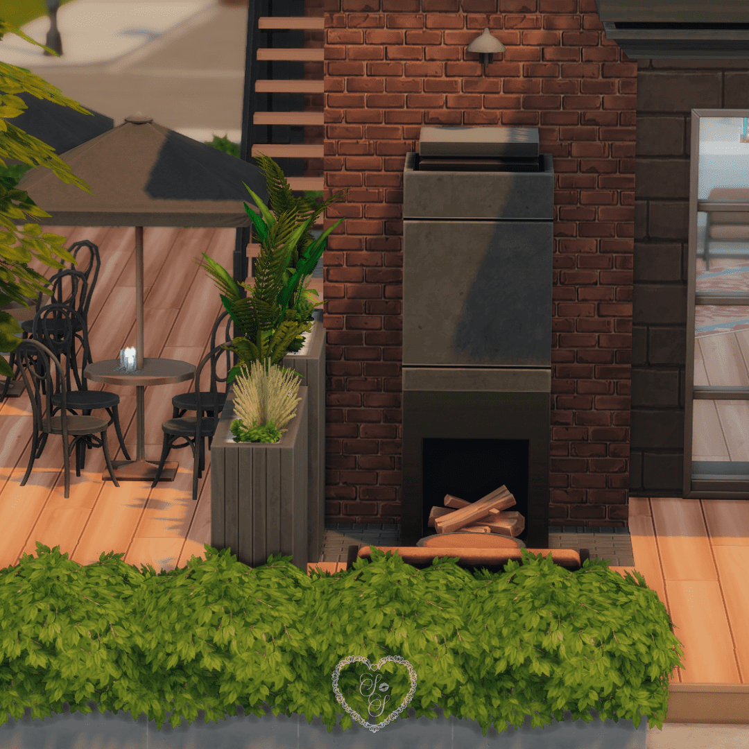 An inviting fireplace nook surrounded by greenery and bistro seating, located just off the side entrance of the Sims 4 Tattoo Shop.