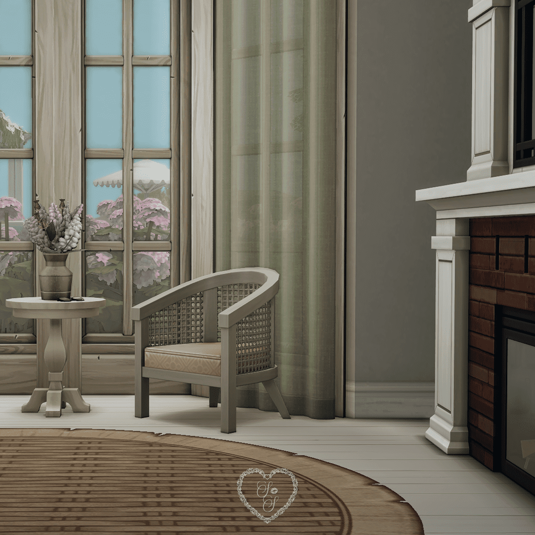 A soft-toned sitting nook with a rattan armchair, floral vase, and fireplace beside tall windows framed by green curtains.