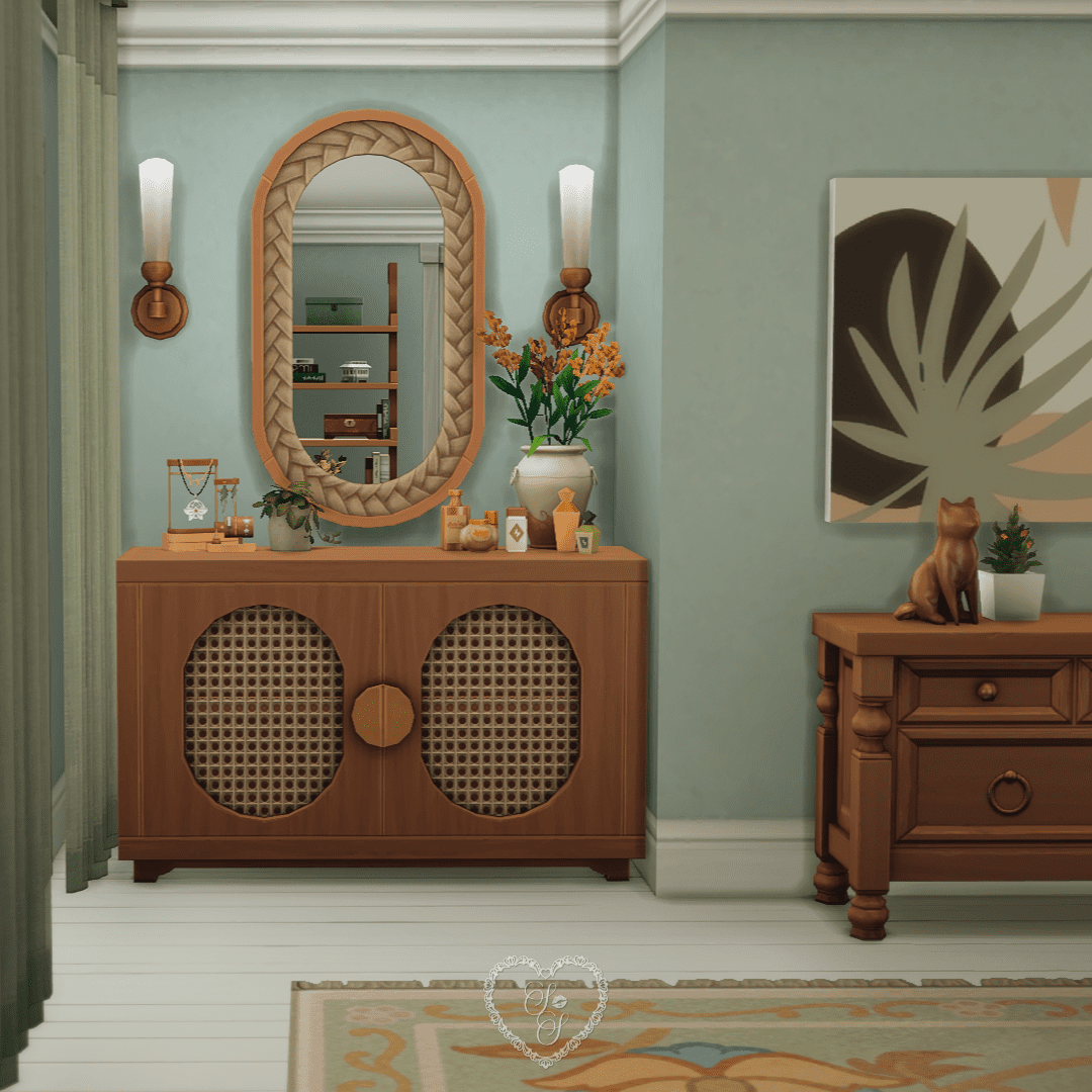 A cozy corner with a wooden vanity, oval mirror, and curated décor like candles, perfume bottles, and jewelry displays.