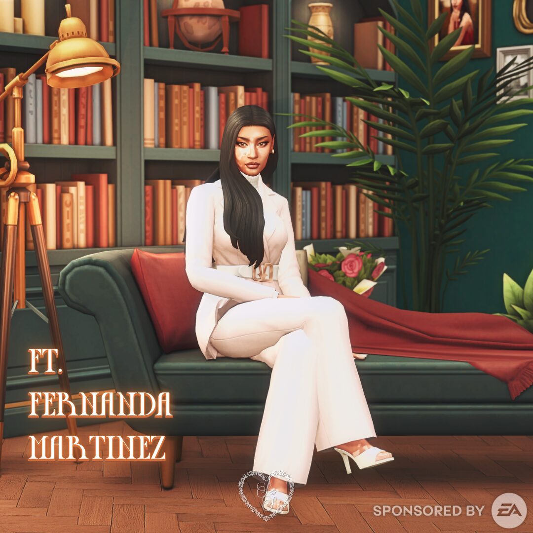 Fernanda Martinez sits poised on a velvet couch, dressed in a sleek white belted pantsuit with heels. She exudes quiet power and timeless grace.