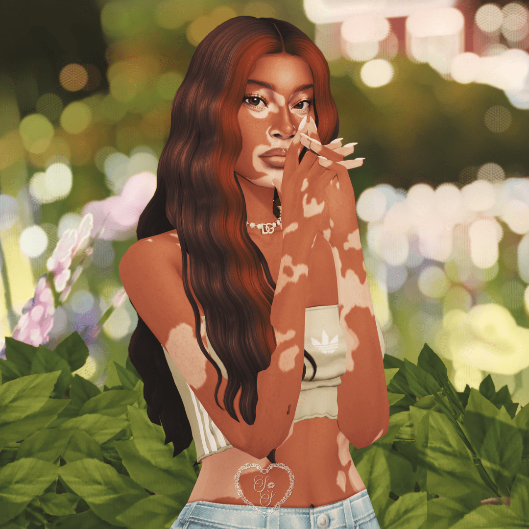 Sim posing with hands near her face, showing long nails and a soft smize in a dreamy garden backdrop.
