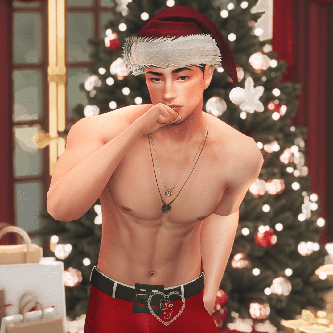 Taeyang leans forward with a hand near his lips, wearing red Santa pants and a festive hat in front of a Sims 4 holiday build.