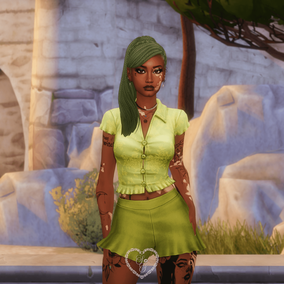 Close-up of a Sim wearing a bright lime green blouse with button details and matching high-waisted shorts, standing against a rocky background.
