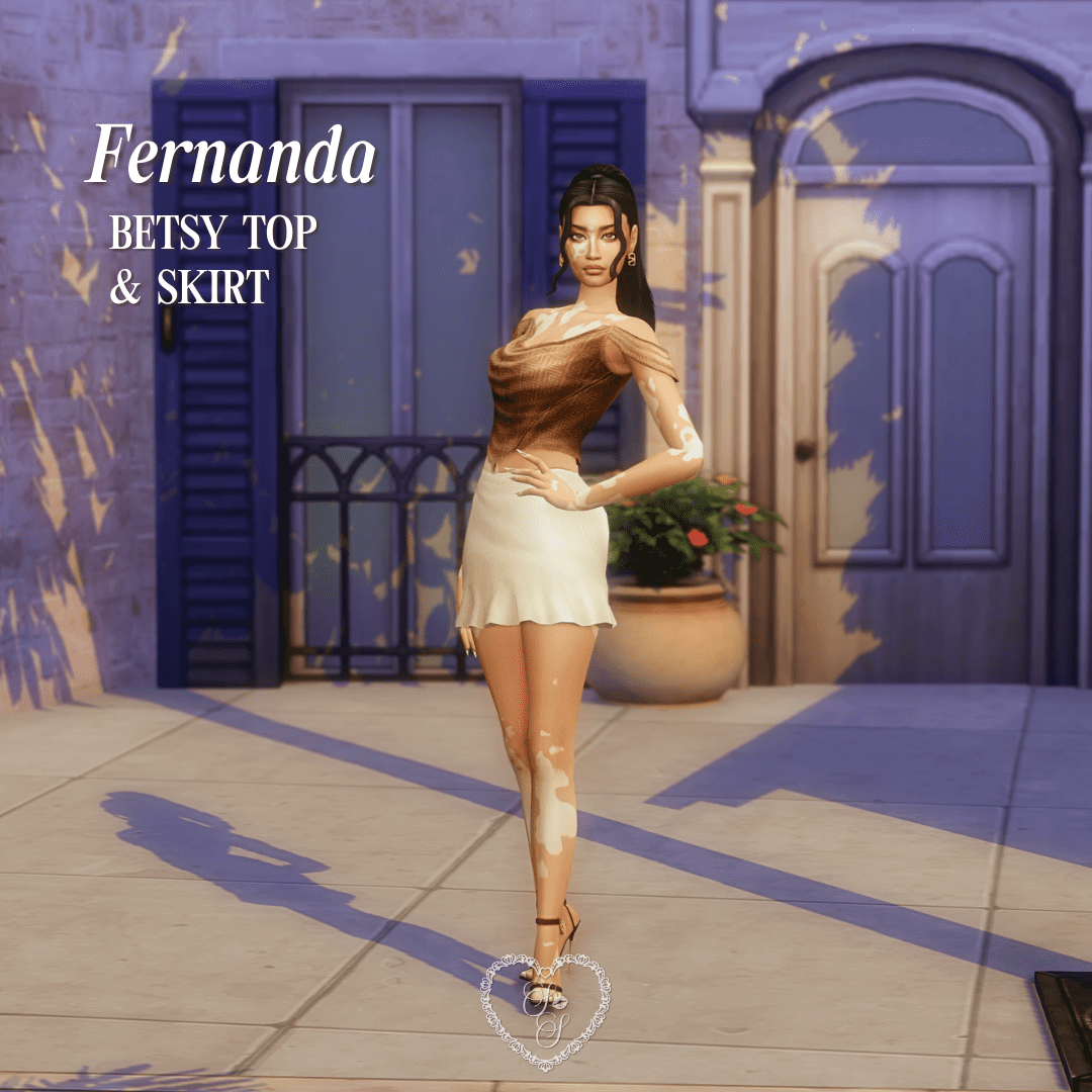 Fernanda poses in front of a pastel villa wearing the Betsy Top and Skirt, styled in soft browns and creams.