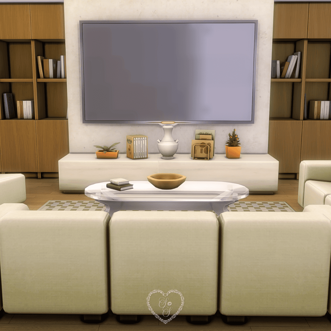 An elegant living room with cream furniture, a flatscreen TV mounted on a pale stone wall, and ambient decor from the Refined Living Room Kit.