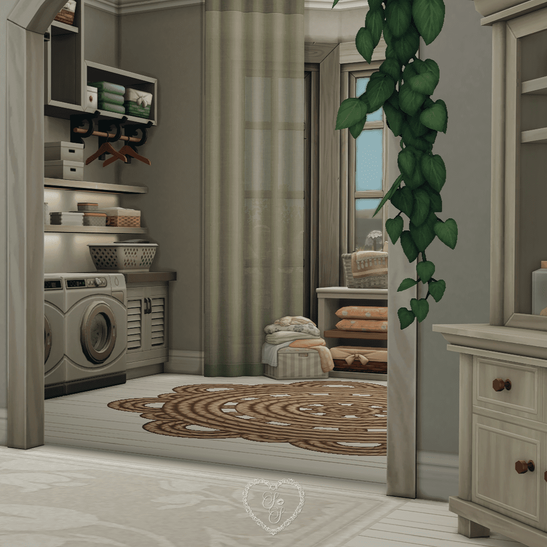 A warm-toned laundry room with neatly folded linens, stacked baskets, open shelving, and a washing machine beneath soft green curtains.