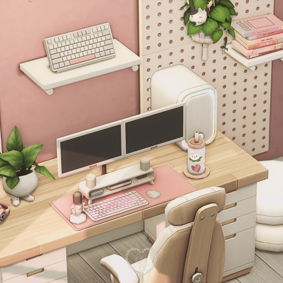 Close-up of a dual-monitor gaming desk with a pink mechanical keyboard, pastel accessories, and a plant in a cat-footed pot on the left.