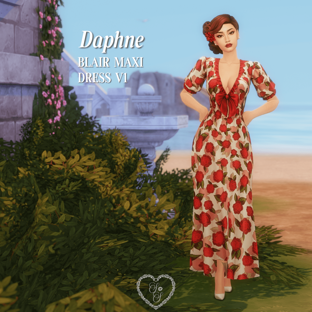Daphne poses near a fountain wearing a cream maxi dress covered in red roses, styled with a bold red bow and romantic updo.