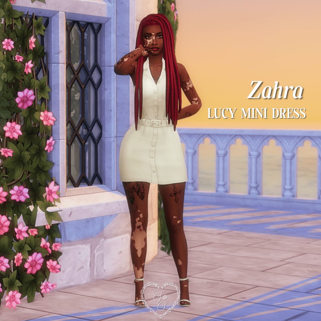 Zahra leans against a pastel wall at golden hour in a sleeveless cream mini dress with a belt, paired with strappy heels and red braids.