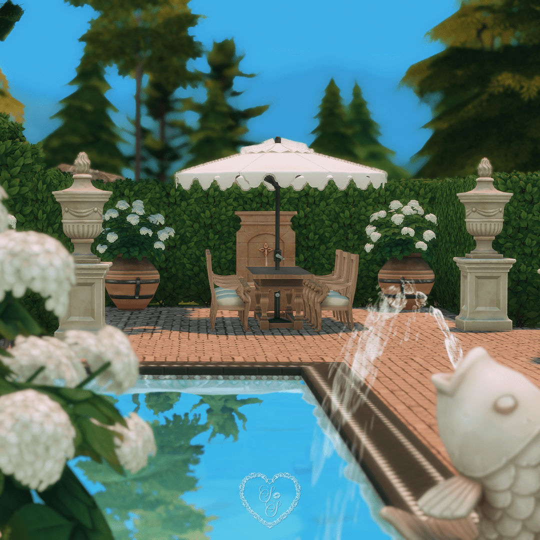 Al fresco dining set with elegant umbrella and wall fountain in this charming outdoor kitchen patio from the Classic Colonial Sims 4 build.